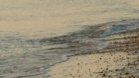 Delaware Bay waves on pebbled beach at sunrise; MCU option; 4K Stock Footage 139018356