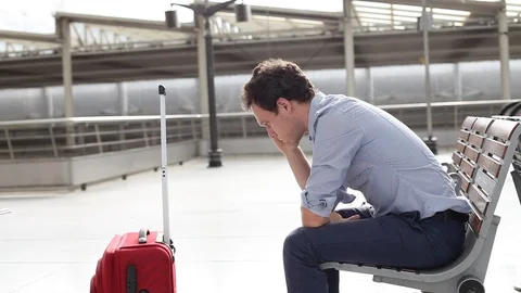 Delay of flight, problem in airport, stressed passenger with luggage waiting Video stock 96127184