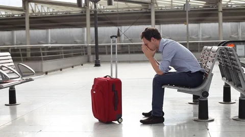 Delay of flight, problem in airport, stressed passenger with luggage waiting Video stock 96127195