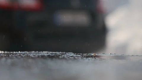 Delayed raindrop falling on cement. The snow is melting Stock Footage 149783851
