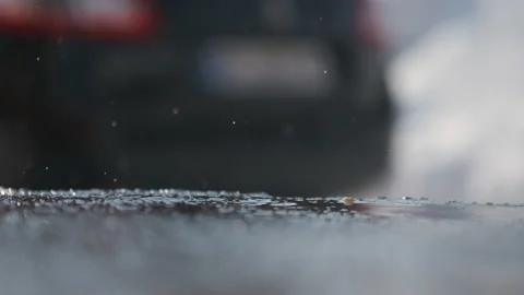 Delayed raindrop falling on cement. The snow is melting Stock Footage 149962121