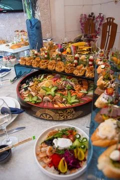 Delectable buffet spread of seafood, sushi, salads, fruit, and pastries. Stock Photos