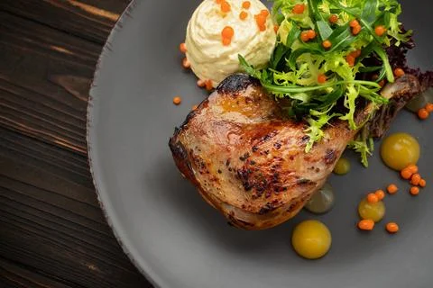Delectable pan-seared duck leg with healthy vegetable medley Stock Photos