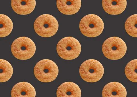 Delectable Pattern of Cinnamon Doughnut on Dark Gray Color Background Stock Photos