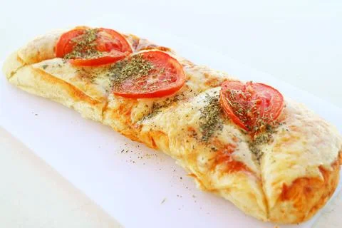 Delectable pizza stick with fresh tomato and herb Stock-Fotos