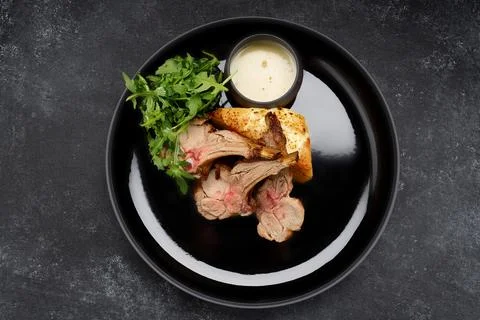 Delectable ribs with grilled vegetable salad and savory sauce Stock Photos
