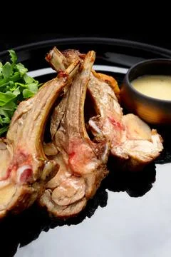 Delectable ribs with grilled vegetable salad and savory sauce Stock Photos