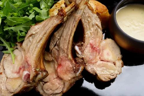 Delectable ribs with grilled vegetable salad and savory sauce Stock Photos