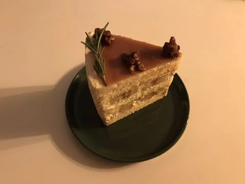 A delectable slice of cake with rich layers of cream and frosting, topped w.. Stock Photos