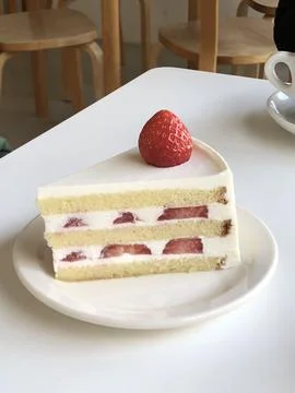 A delectable slice of cake with rich layers of cream and frosting, topped w.. 写真素材
