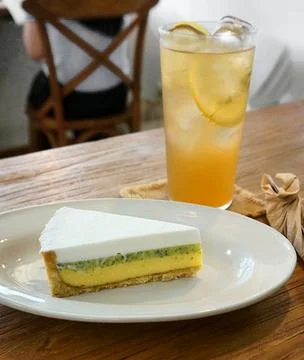 A delectable slice of cake with rich layers of cream and frosting, topped w.. Stock Photos
