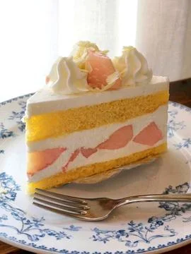 A delectable slice of cake with rich layers of cream and frosting, topped w.. Stock Photos