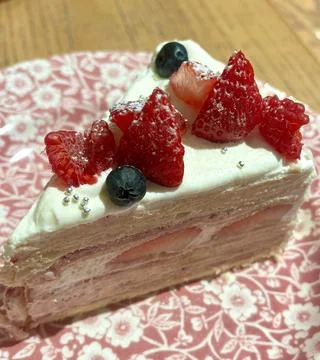 A delectable slice of cake with rich layers of cream and frosting, topped w.. Stock Photos