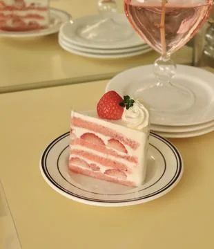 A delectable slice of cake with rich layers of cream and frosting, topped w.. Stock Photos