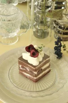 A delectable slice of cake with rich layers of cream and frosting, topped w.. Stock Photos