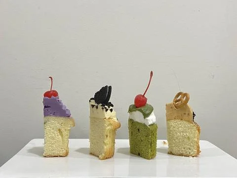 A delectable slice of cake with rich layers of cream and frosting, topped w.. 写真素材