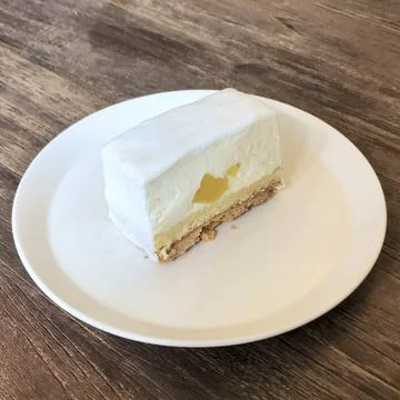 A delectable slice of cake with rich layers of cream and frosting, topped w.. Stock Photos
