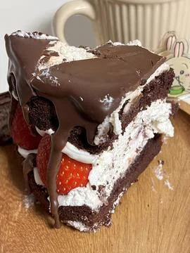 A delectable slice of cake with rich layers of cream and frosting, topped w.. Stock Photos