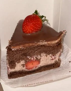 A delectable slice of cake with rich layers of cream and frosting, topped w.. Stock Photos