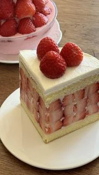 A delectable slice of cake with rich layers of cream and frosting, topped w.. Stock Photos