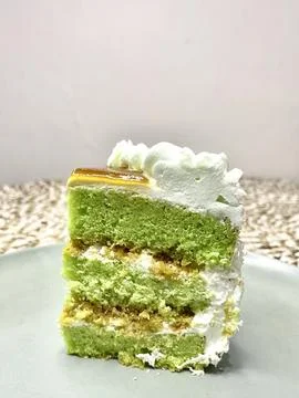 A delectable slice of cake with rich layers of cream and frosting, topped w.. 写真素材