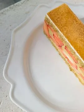 A delectable slice of cake with rich layers of cream and frosting, topped w.. Stock Photos