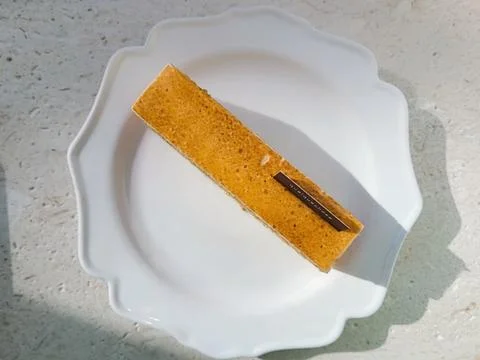 A delectable slice of cake with rich layers of cream and frosting, topped w.. Stock Photos