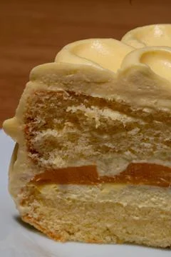 A delectable slice of mango layer cake presented with fluffy sponge and smo.. Stock Photos