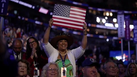 A delegate in a cowboy hat holds up an American flag and cheers, RNC Dallas 2026 Stock Footage 345271598