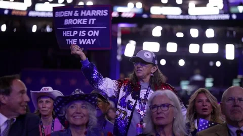 A delegate holds a sign reading 'Biden and Harris Broke It - Help Is On The Way' Stock-Footage 345274173