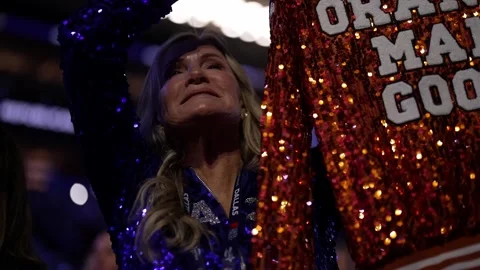 A delegate in a sequined outfit cheers during President Donald Trump's speech Stock Footage 345271594