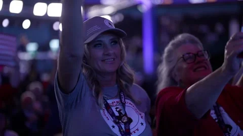 A delegate waves toward the stage as others cheer, RNC Dallas 2026 Stock Footage 345274198