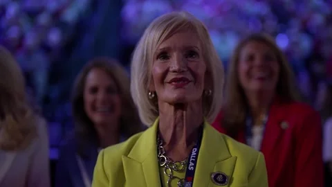 A delegate in a yellow jacket smiles and applauds, RNC Dallas 2026 Stock Footage 345274958