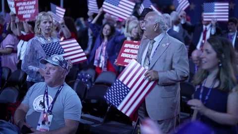 Delegates carry American flag placards across the convention floor Stock Footage 345274217