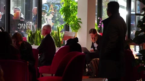 Delegates in a hotel lounge during the World Economic Forum Annual Meeting Stock Footage 345299444