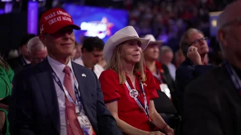 Delegates, including a man in a cowboy hat, listen to speeches, RNC Dallas 2026 Stock Footage 345274158