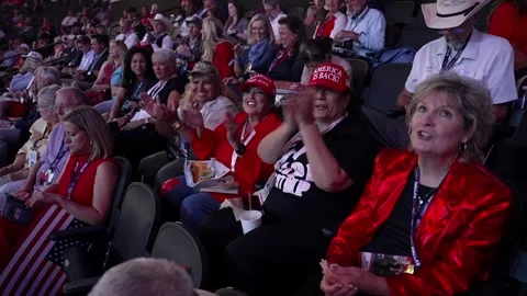 Delegates, one in a red sequined jacket, react to speeches in the stands Stock Footage 345272189