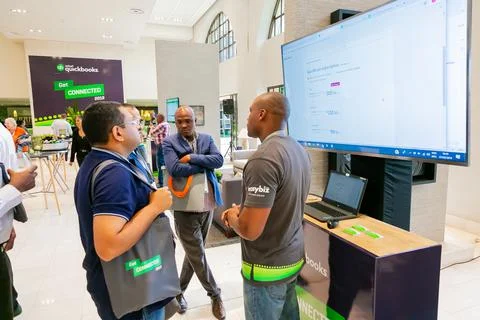 Delegates with the same shirts networking at accountancy conference in South Afr Fotos Stock