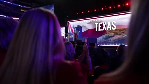 Delegates watch a 'Texas' video on the stage screen, RNC Dallas 2026 Stock-Footage 345271353