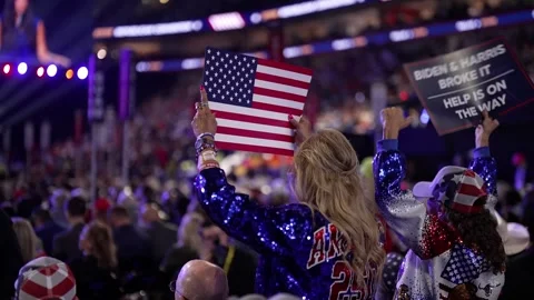 Delegates wave American flags and 'Biden and Harris Broke It' signs Stock Footage 345274182