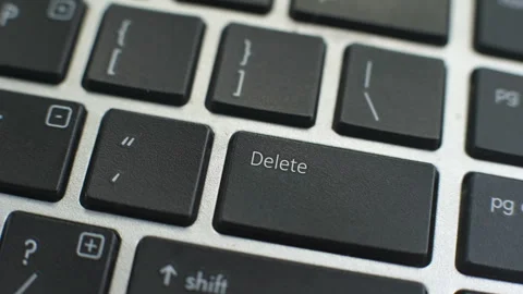 Delete button on computer keyboard, female hand fingers press key Stock Footage 97828349