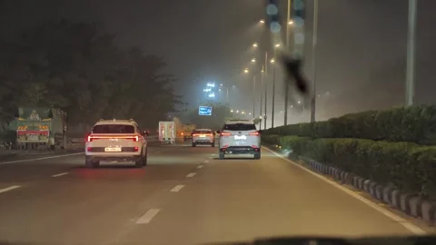 Delhi, India: 22 December 2025 - Inside cab moving through city traffic Stock Footage 331877553