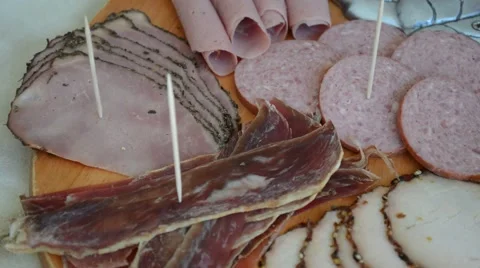 Deli meat on wooden plate Stock Footage