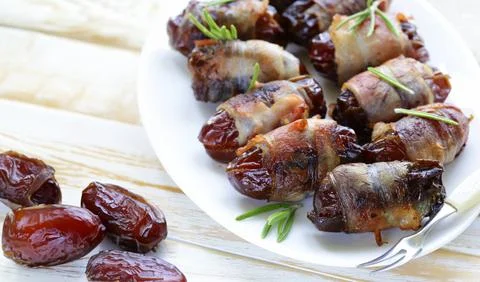 Delicacy appetizer fried dates with bacon and rosemary Stock Photos