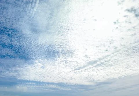 Delicate altocumulus clouds across blue sky natural cloud texture background Stock Photos