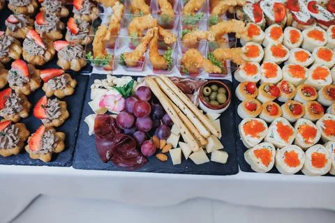 Delicate appetizers arranged on dark stone boards Foto stock