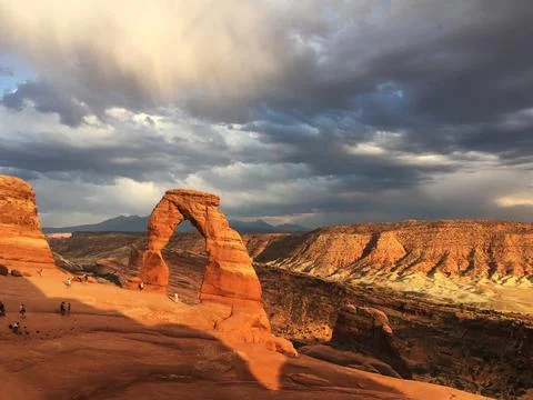 Delicate Arch with dramatic clouds Arches National Park, UT Stock Photos