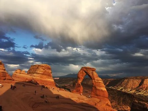 Delicate Arch with dramatic clouds Arches National Park, UT Stock Photos