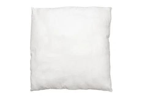 Delicate bedroom textiles, comfortable soft pillow with artificial filling. Stock Photos