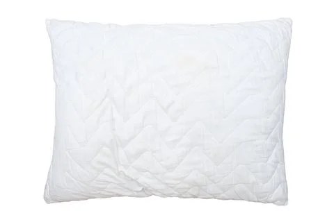 Delicate bedroom textiles, comfortable soft pillow with artificial filling. Stock Photos